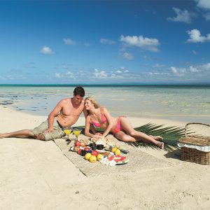 Couple on beach at Jean Michel Cousteau Resort