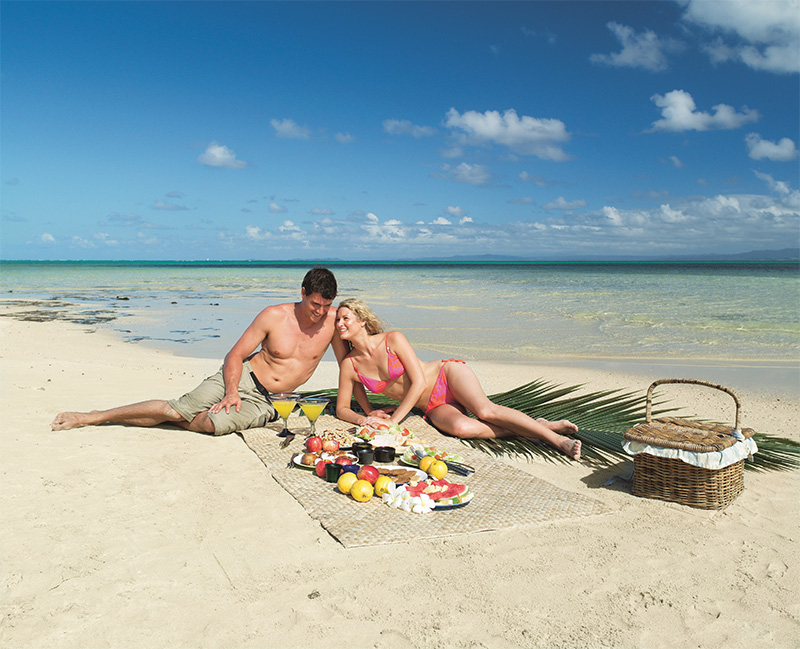 Couple on beach at Jean Michel Cousteau Resort