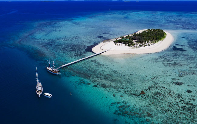 exclusive atoll surrounded by a circle of white sandy beach 