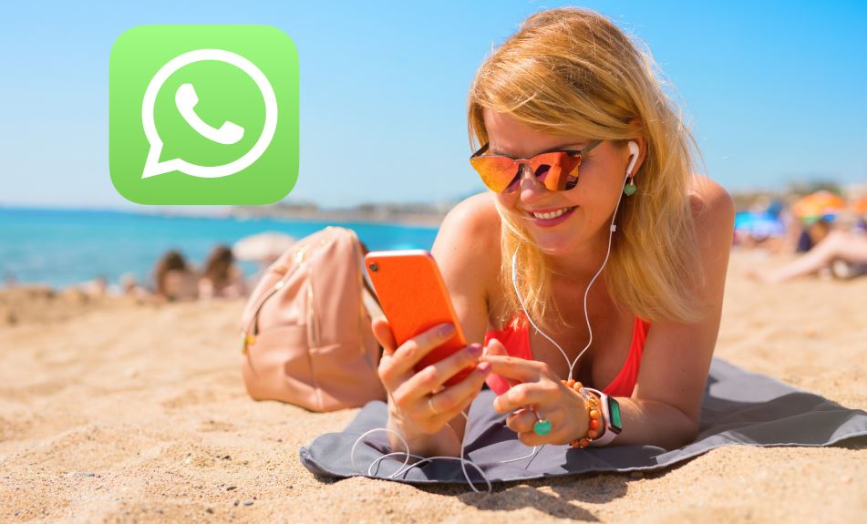 Woman using phone with Whatsapp at the beach